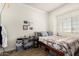 Casual bedroom with neutral walls, patterned bedding, and a window overlooking outdoors at 4931 E Paradise Ln, Scottsdale, AZ 85254