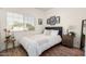 Cozy bedroom with decorative prints above the bed and wooden nightstand at 4931 E Paradise Ln, Scottsdale, AZ 85254