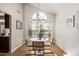 Bright breakfast nook features chandelier lighting, a white table, and large bright window at 4931 E Paradise Ln, Scottsdale, AZ 85254