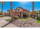 Charming two-story home with a tile roof, well-manicured lawn, and lush landscaping at 4931 E Paradise Ln, Scottsdale, AZ 85254