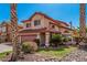 Inviting two-story home with manicured landscaping, a two-car garage, and a charming front yard at 4931 E Paradise Ln, Scottsdale, AZ 85254