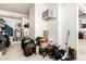 Organized storage area in the garage with shelves, boxes, and a wall-mounted air conditioner at 4931 E Paradise Ln, Scottsdale, AZ 85254