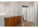 Hallway with a wooden cabinet and a doorway leading to another room at 4931 E Paradise Ln, Scottsdale, AZ 85254