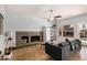 Inviting living room with tile floors, stylish furniture, and a cozy fireplace at 4931 E Paradise Ln, Scottsdale, AZ 85254