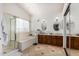 Bright bathroom featuring dual vanities, soaking tub, and a separate shower at 4931 E Paradise Ln, Scottsdale, AZ 85254