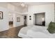 Bedroom with light colored walls, wood look tile, and en-suite bathroom at 4931 E Paradise Ln, Scottsdale, AZ 85254