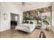 Bedroom with light colored walls, wood look tile, and en-suite office at 4931 E Paradise Ln, Scottsdale, AZ 85254