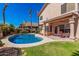 Inviting backyard pool with lush landscaping, a covered patio, and outdoor dining area at 4931 E Paradise Ln, Scottsdale, AZ 85254