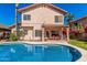 Refreshing backyard pool with a view of the home's patio and well-maintained landscaping at 4931 E Paradise Ln, Scottsdale, AZ 85254