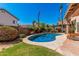 Beautiful backyard featuring a refreshing pool, mature trees, and a well-manicured lawn at 4931 E Paradise Ln, Scottsdale, AZ 85254