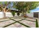 Low-maintenance backyard featuring tiled patio, artificial grass, and desert landscaping at 5127 N 71St St, Paradise Valley, AZ 85253