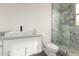 Modern bathroom features a white vanity, black faucet, sleek toilet and tiled shower at 5127 N 71St St, Paradise Valley, AZ 85253