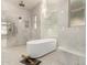 Luxurious bathroom featuring a standalone tub, marble finishes, and modern lighting fixtures at 5127 N 71St St, Paradise Valley, AZ 85253