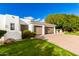 Contemporary home showcasing a spacious three-car garage, complemented by well-manicured lawn and desert landscaping at 5127 N 71St St, Paradise Valley, AZ 85253