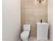 This powder room features a modern, minimalist design with light wood tile and stylish fixtures at 5127 N 71St St, Paradise Valley, AZ 85253