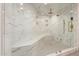 The shower features a built-in bench, luxurious marble, and sleek fixtures at 5127 N 71St St, Paradise Valley, AZ 85253