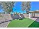 A backyard with green turf, rock landscaping, and a covered patio at 520 W Gibraltar Ln, Phoenix, AZ 85023