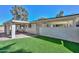 Backyard featuring green turf, rock landscaping, and a covered patio at 520 W Gibraltar Ln, Phoenix, AZ 85023