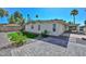 Backyard featuring green turf, rock landscaping, a paved patio, and a covered carport at 520 W Gibraltar Ln, Phoenix, AZ 85023