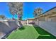 A backyard with green turf, rock landscaping, and a covered patio at 520 W Gibraltar Ln, Phoenix, AZ 85023