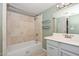 Neutral bathroom featuring a shower-tub combination and a light-colored vanity with a gray cabinet at 520 W Gibraltar Ln, Phoenix, AZ 85023