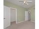 Cozy bedroom featuring carpeted floors, neutral walls, ceiling fan and walk-in closet at 520 W Gibraltar Ln, Phoenix, AZ 85023