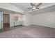 Spacious bedroom with carpet flooring, a ceiling fan, closet space, and a connecting bathroom at 520 W Gibraltar Ln, Phoenix, AZ 85023