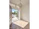 Inviting foyer with wood-look tile flooring and a modern light fixture, offering a glimpse of the home's exterior at 520 W Gibraltar Ln, Phoenix, AZ 85023