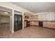 Kitchen featuring wood-look tile floors, wooden cabinets, and black appliances at 520 W Gibraltar Ln, Phoenix, AZ 85023