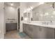 Stylish bathroom with a double sink vanity, quartz countertops, and a large mirror with decorative lighting at 6804 E Lyra Dr, Scottsdale, AZ 85257