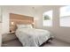 Cozy bedroom with a decorative headboard, modern lighting, and natural light from the windows at 6804 E Lyra Dr, Scottsdale, AZ 85257