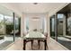 Bright dining room with a modern glass table and sliding glass doors leading to an outdoor space at 6804 E Lyra Dr, Scottsdale, AZ 85257