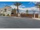 View of the community entrance showcasing a wooden gate and desert landscaping under a blue sky at 6804 E Lyra Dr, Scottsdale, AZ 85257