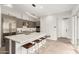 Contemporary kitchen with a large island featuring seating, modern lighting, and stainless steel appliances at 6804 E Lyra Dr, Scottsdale, AZ 85257