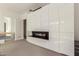 Sleek modern living room featuring a built-in fireplace and high gloss white cabinets at 6804 E Lyra Dr, Scottsdale, AZ 85257