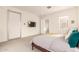 Bright bedroom with en-suite bathroom access, a wall-mounted TV, and a serene color palette at 6804 E Lyra Dr, Scottsdale, AZ 85257