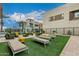 Community pool area with lounge chairs, turf and desert landscaping, offering a relaxing outdoor space for residents at 6804 E Lyra Dr, Scottsdale, AZ 85257