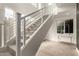 Modern staircase with sleek railings, plush carpet, and bright windows, enhancing the home's contemporary design at 6804 E Lyra Dr, Scottsdale, AZ 85257