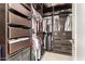 Well-organized walk-in closet with dark wood shelving, drawers, hanging racks and carpet floors at 6804 E Lyra Dr, Scottsdale, AZ 85257