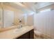 Bathroom featuring a large mirror, neutral counter tops and a shower tub combination at 7741 W Giles Rd, Phoenix, AZ 85035