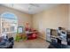 Bedroom featuring a large window with blinds and carpeted flooring at 7741 W Giles Rd, Phoenix, AZ 85035