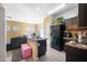 Open kitchen area with dark cabinets, neutral paint and laminate flooring at 7741 W Giles Rd, Phoenix, AZ 85035