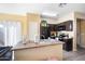 Functional kitchen featuring dark cabinets, laminate counters and black appliances at 7741 W Giles Rd, Phoenix, AZ 85035