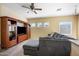 Comfortable living room featuring a large entertainment center and plush sectional sofa at 7741 W Giles Rd, Phoenix, AZ 85035