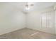 This bedroom is tiled, has a window, and includes a ceiling fan with lights at 7910 W Adobe Dr, Glendale, AZ 85308