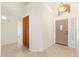 Inviting entryway with tiled flooring, a storage closet, and a view of the front door with decorative glass at 7910 W Adobe Dr, Glendale, AZ 85308