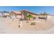 Well-landscaped front yard featuring desert plants, a small palm tree, and a view of the home's exterior at 7910 W Adobe Dr, Glendale, AZ 85308