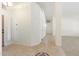 Hallway showcasing tiled flooring, neutral paint, and access to various rooms throughout the home at 7910 W Adobe Dr, Glendale, AZ 85308