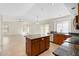 Bright, open kitchen featuring a center island and adjacent living area at 7910 W Adobe Dr, Glendale, AZ 85308