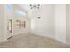 Well-lit room showcasing tiled floors, modern lighting, plantation shutters and neutral wall paint at 7910 W Adobe Dr, Glendale, AZ 85308